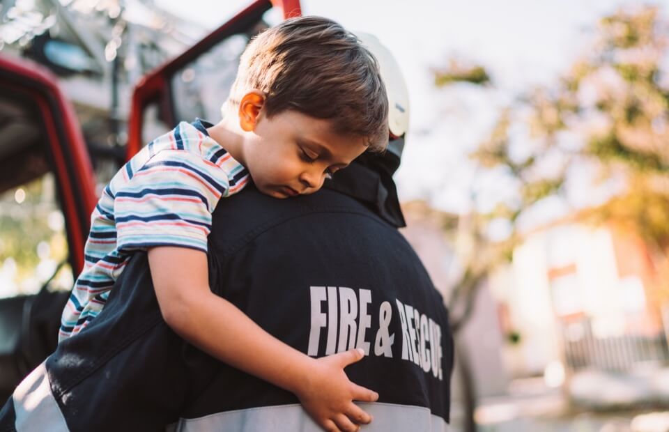 promo image for firefighter helping child